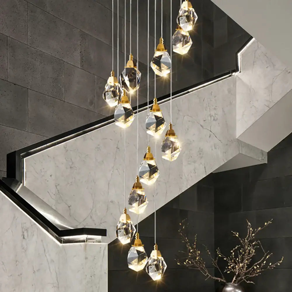 A modern gold diamond crystal led ceiling chandelier with faceted clear glass pendants for dining room use