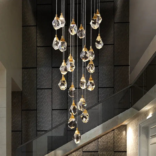 A modern gold diamond crystal led ceiling chandelier with faceted clear glass pendants for dining room use