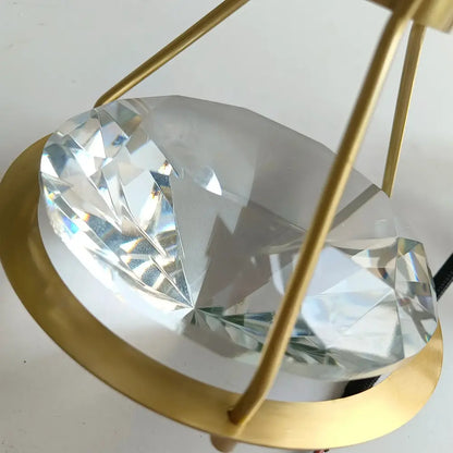 Modern gold diamond crystal pendant light featuring a clear faceted crystal diamond pendant in a gold-toned frame for bedroom illumination pendant lights