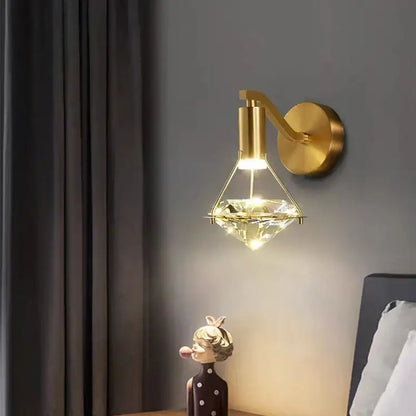 Modern gold diamond crystal wall lamp featuring a gold-finished wall sconce with a diamond-shaped crystal pendant
