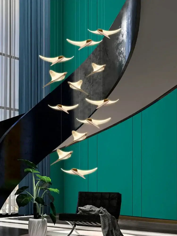 Modern gold dolphin pendant chandelier with sleek wing-shaped light fixtures in curved metallic arc for hotel lobby decorbites dolphin pendant