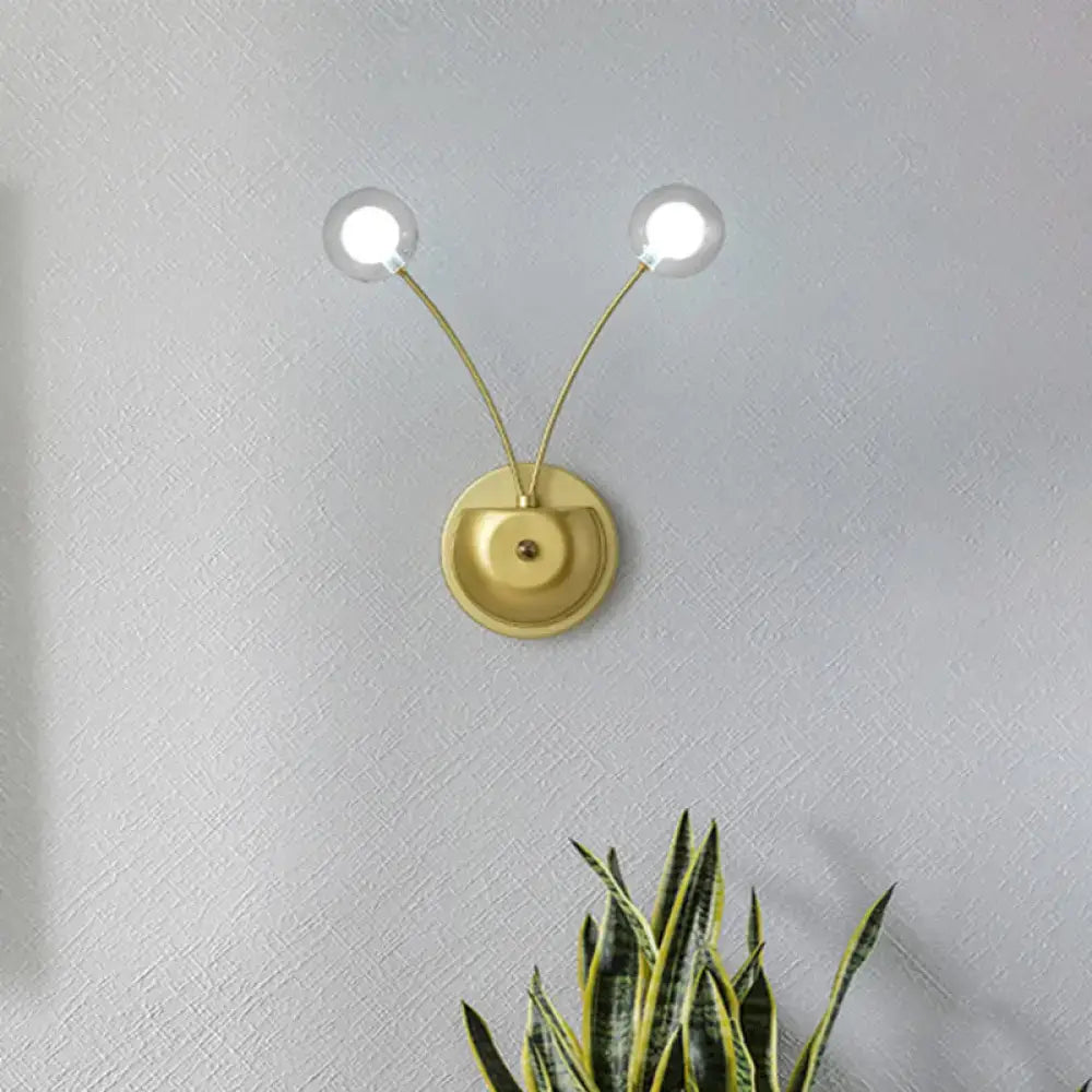 Modern gold double arm wall lamp with clear globe bulbs and inch fixture ideal for bedroom lighting