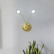 Modern gold double arm wall lamp with clear globe bulbs and inch fixture ideal for bedroom lighting