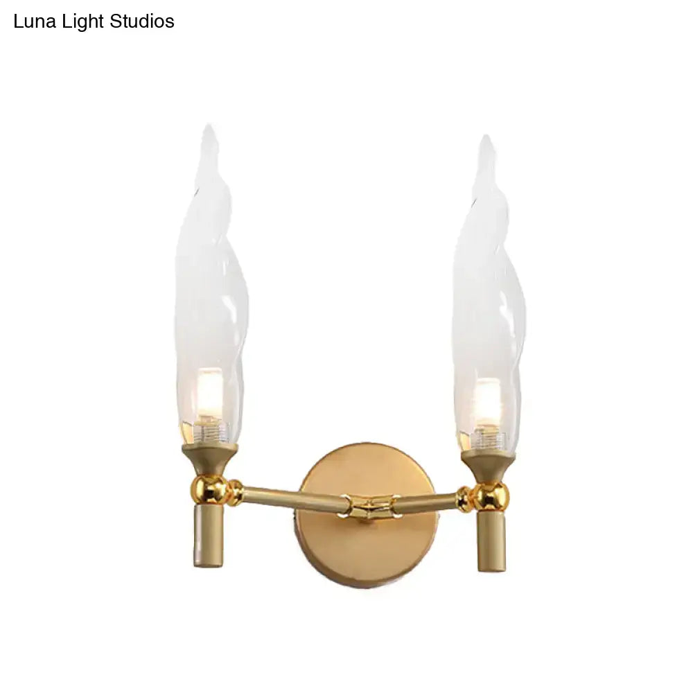 Modern gold double arm wall sconce with flame-shaped glass shades ideal for living room lighting