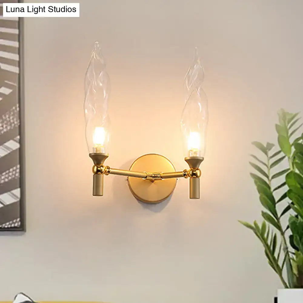 Modern gold double arm wall sconce with twisted glass flame-shaped shades for living room use