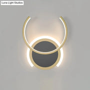 Modern gold dual ring led wall sconce with two concentric circular rings emitting a warm glow for bedroom lighting