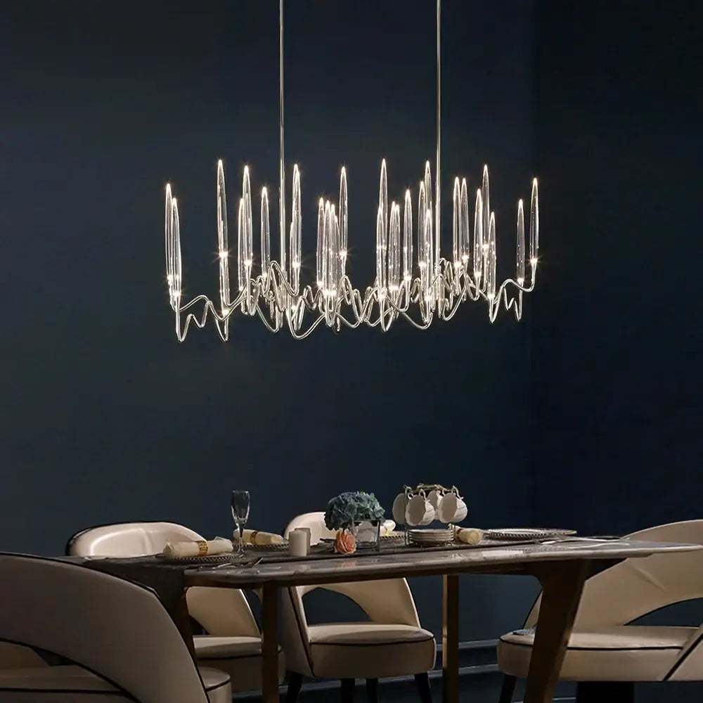 Modern gold elegant candle shape ceiling chandelier with slender transparent glass arms and sleek metallic frame decorbites elegant candle