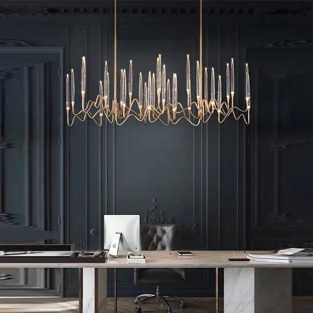 Modern gold elegant candle shape ceiling chandelier with clear glass arms above a desk for decorbites elegant candle decor