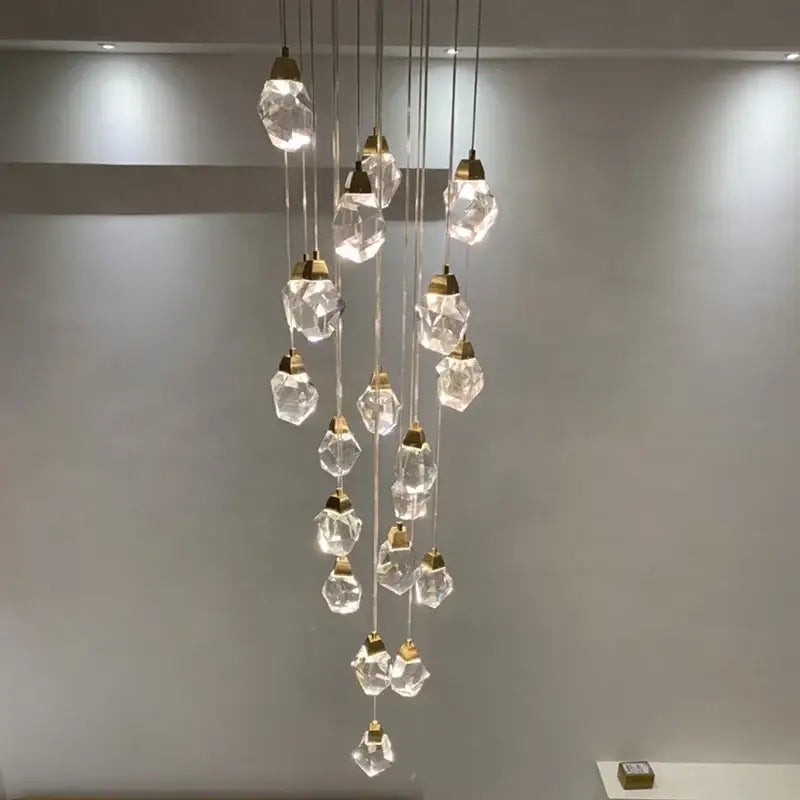 Modern gold elegant crystal chandelier with faceted clear glass pendants and gold-toned metal fixtures by decorbites elegant