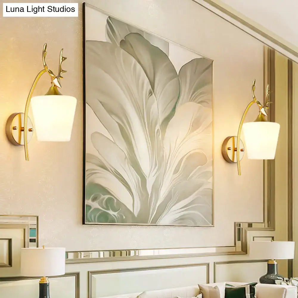Modern gold elk led incandescent wall sconce features gold-toned deer antler design with frosted white glass shades