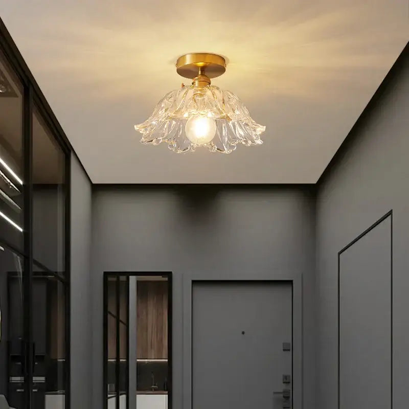 Modern gold etched glass led ceiling lamp featuring a clear glass petal design with a golden brass base for living rooms