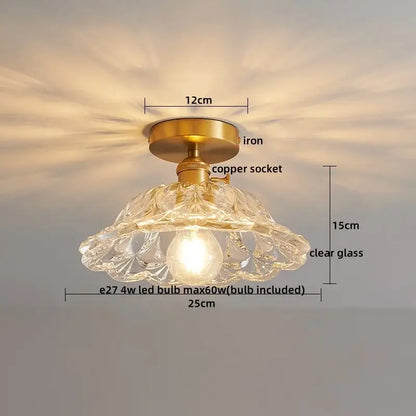 A delicate clear glass pendant led ceiling lamp with a brass iron base and copper socket for living room use