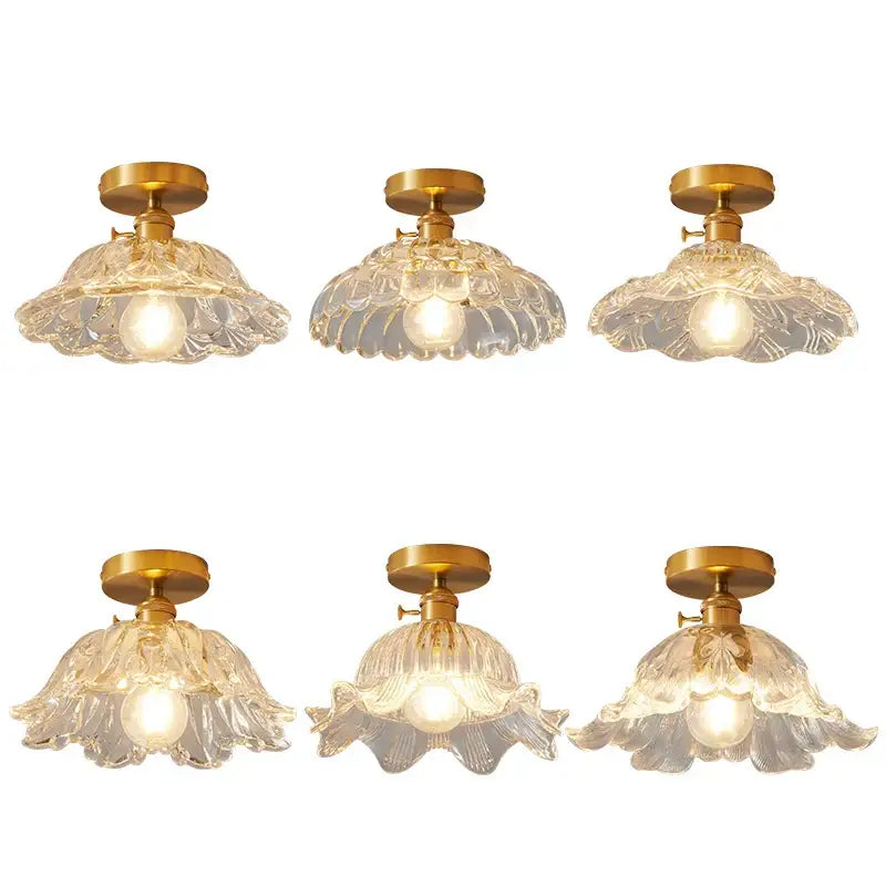 Set of six clear glass flower-shaped led ceiling lamps with gold-toned metal fixtures for modern living rooms