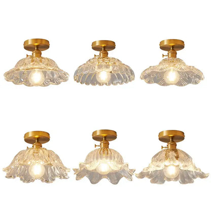 Set of six clear glass flower-shaped led ceiling lamps with gold-toned metal fixtures for modern living rooms
