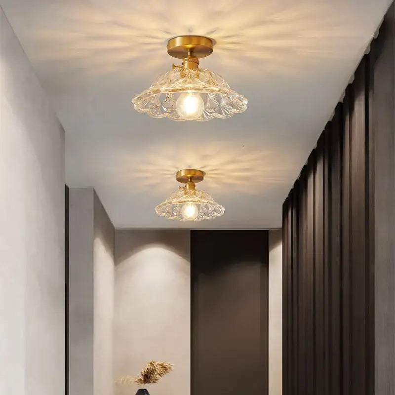 Two elegant crystal glass flush mount led ceiling lamps with gold-toned metal fixtures for living room lighting