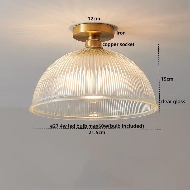 A vintage-style led ceiling lamp with brass iron base copper socket and clear ribbed glass shade for living rooms