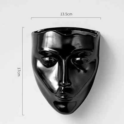 Black glossy decorbites ceramic wall-mounted face sculpture with smooth contours, ideal as a ceramic wall-mounted vase decor