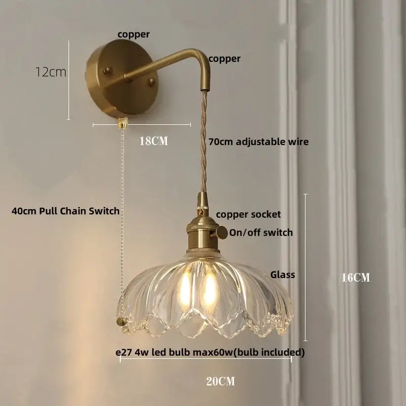 Modern copper-finished wall light with clear petal-shaped glass shade and adjustable wire ideal for bedroom use