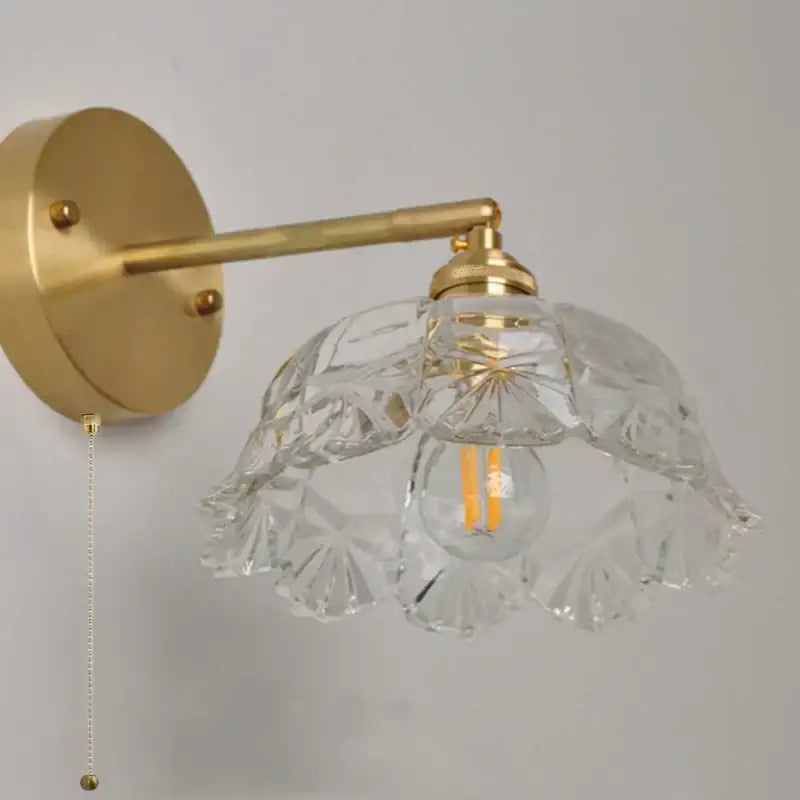 Modern gold faceted clear glass wall light with intricate cut patterns and gold-toned metal arm for bedroom decorbites clear glass