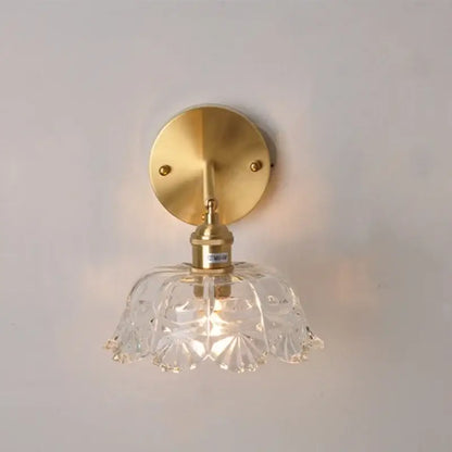 Modern gold faceted clear glass wall light with brass mounting plate and stem for bedroom decorbites clear glass sconce