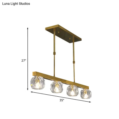 Modern gold island pendant light with rectangular frame and four faceted crystal sphere globe shades for kitchen or dining room