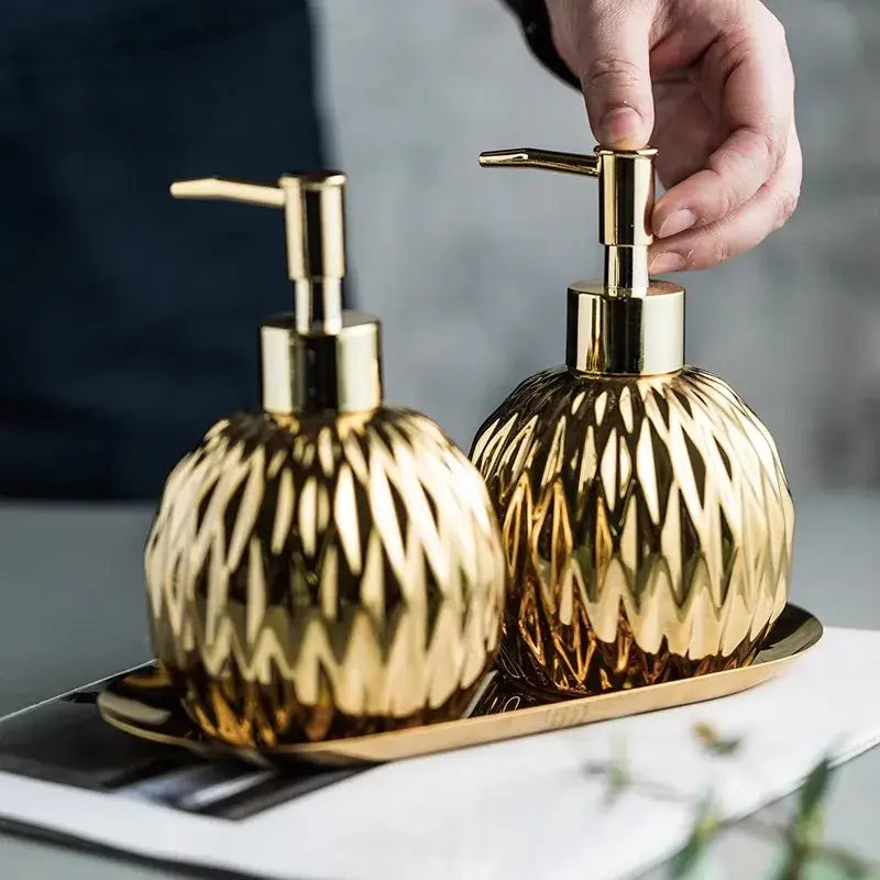 Modern gold faceted glass liquid soap dispenser set with matching pump tops for bathroom decor and liquid soap use