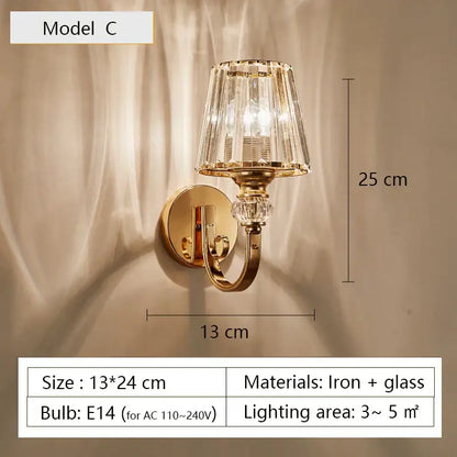 Modern gold wall lamp featuring a faceted crystal glass shade with decorative crystal accents for living room use