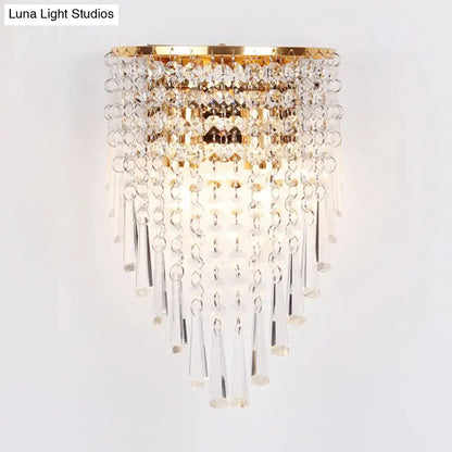 Modern gold finish wall light with clear crystal droplets and prisms designed for bedroom sconce lighting