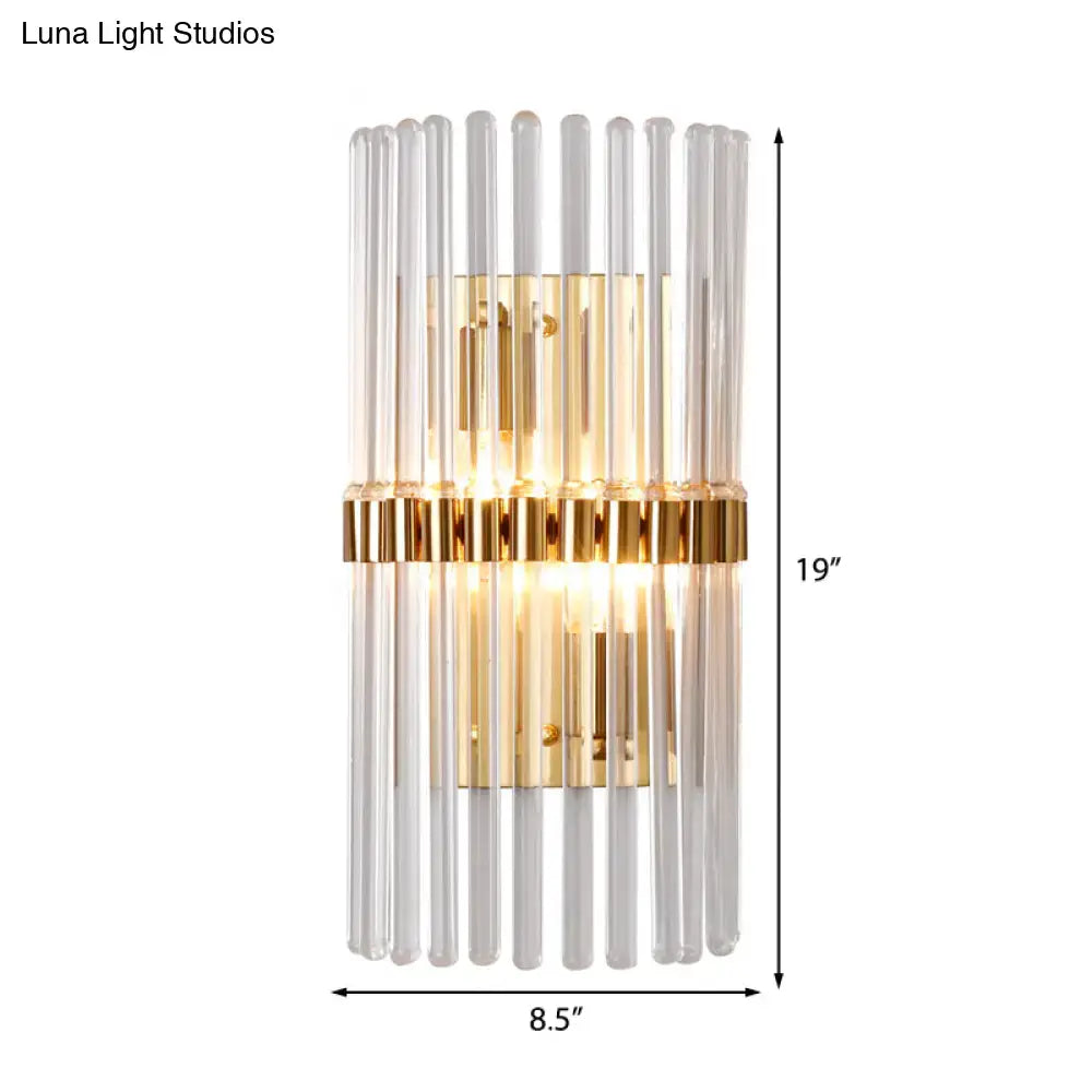 Modern gold finish wall light with clear crystal vertical glass tubes framed by polished metal for living room sconce