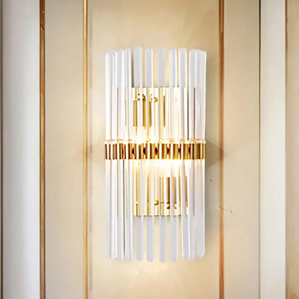 Modern gold finish wall light with vertical clear crystal frosted glass rods and central illuminated panel for living room