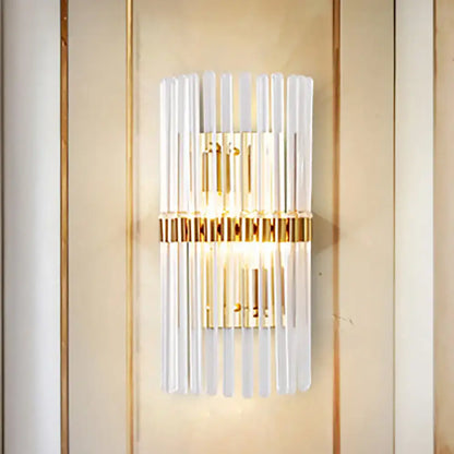 Modern gold finish wall light with vertical clear crystal frosted glass rods and central illuminated panel for living room