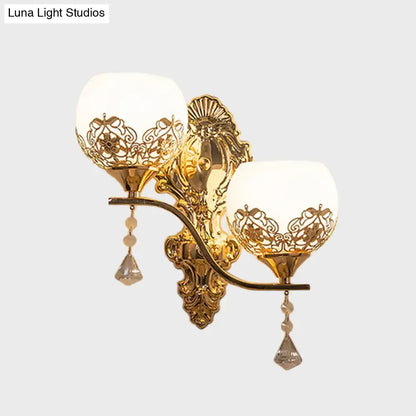 Modern gold finish dome wall sconce with ornate lace-like shades and crystal pendants for living room lighting