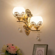 Modern gold finish dome wall sconce with two frosted glass globes and dangling crystals for living room decor