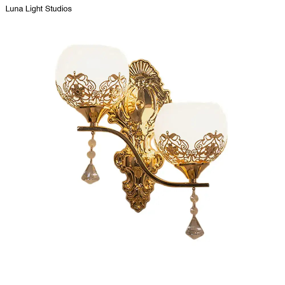Modern gold finish dome wall sconce with two frosted glass shades and crystal teardrop pendants for living room