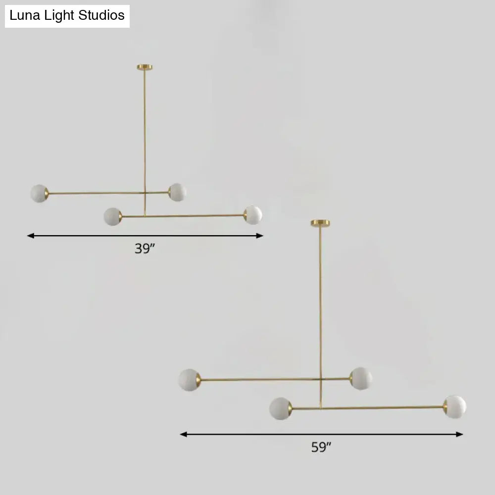 Modern minimalist pendant light with gold finish metal frame and five white opal glass globes with bulb base