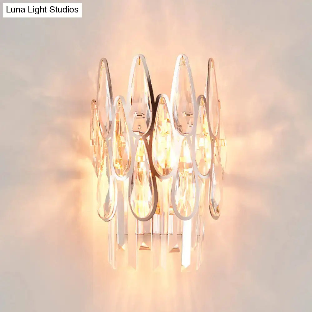 Modern gold finish wall lamp with clear teardrop crystal cluster and sleek chrome base for elegant bedroom sconce