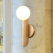Modern gold finish wall sconce with sleek curved metal arm and milky glass shade for elegant bedroom lighting