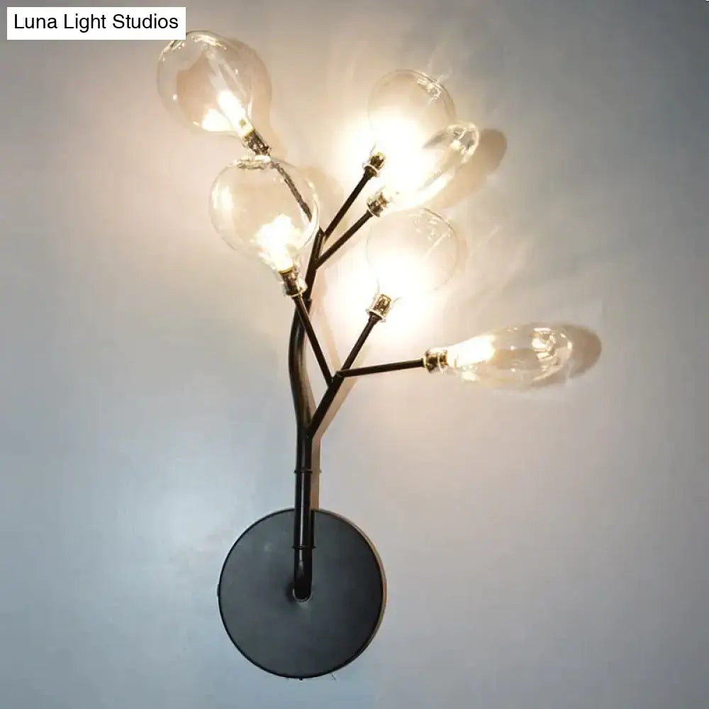 Black metal led wall light with five clear glass bulb arms resembling a tree branch for modern bedroom use