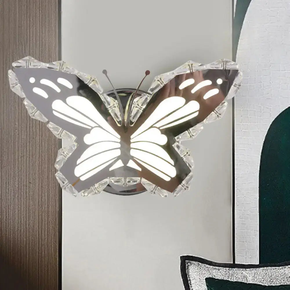 Modern gold fish wall sconce with crystal shade and stainless steel body featuring crystal-encrusted butterfly wings and warm white light
