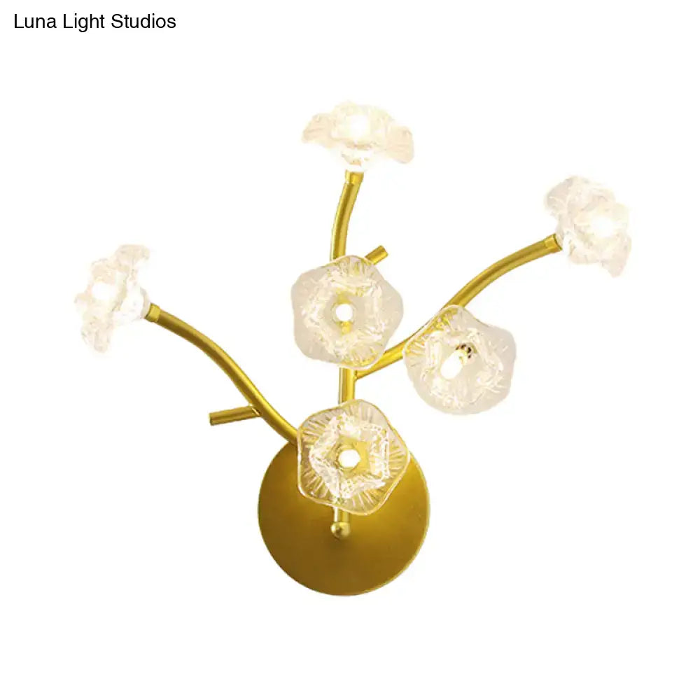 Modern gold floral bedside wall mount lamp with five translucent flower-shaped glass shades on curved branches light fixture