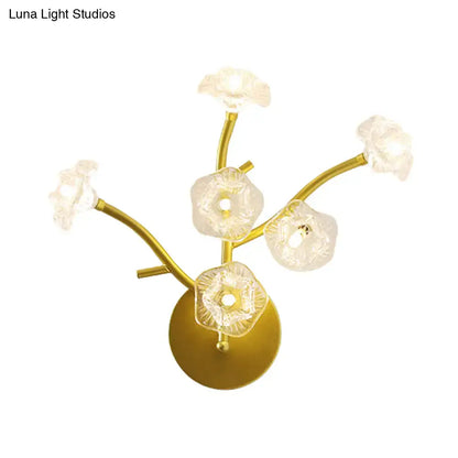 Modern gold floral bedside wall mount lamp with five translucent flower-shaped glass shades on curved branches light fixture