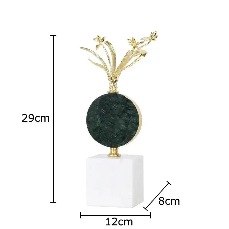 Elegant gold-toned flower crystal sculpture atop dark green stone on white marble base for modern desk decoration
