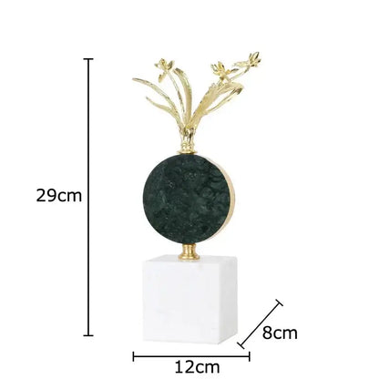 Elegant gold-toned flower crystal sculpture atop dark green stone on white marble base for modern desk decoration