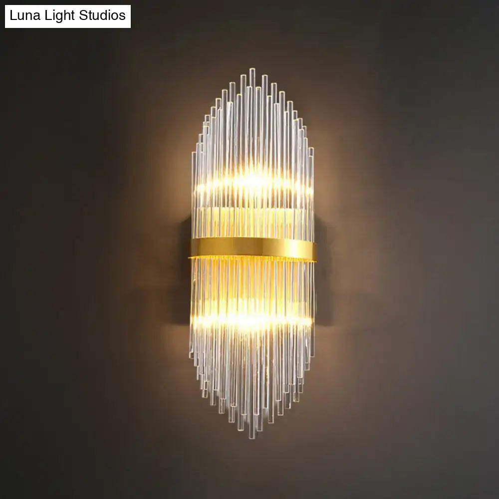Modern gold flute shaped wall sconce with clear crystal rods and cascading glass design for elegant bedroom lighting