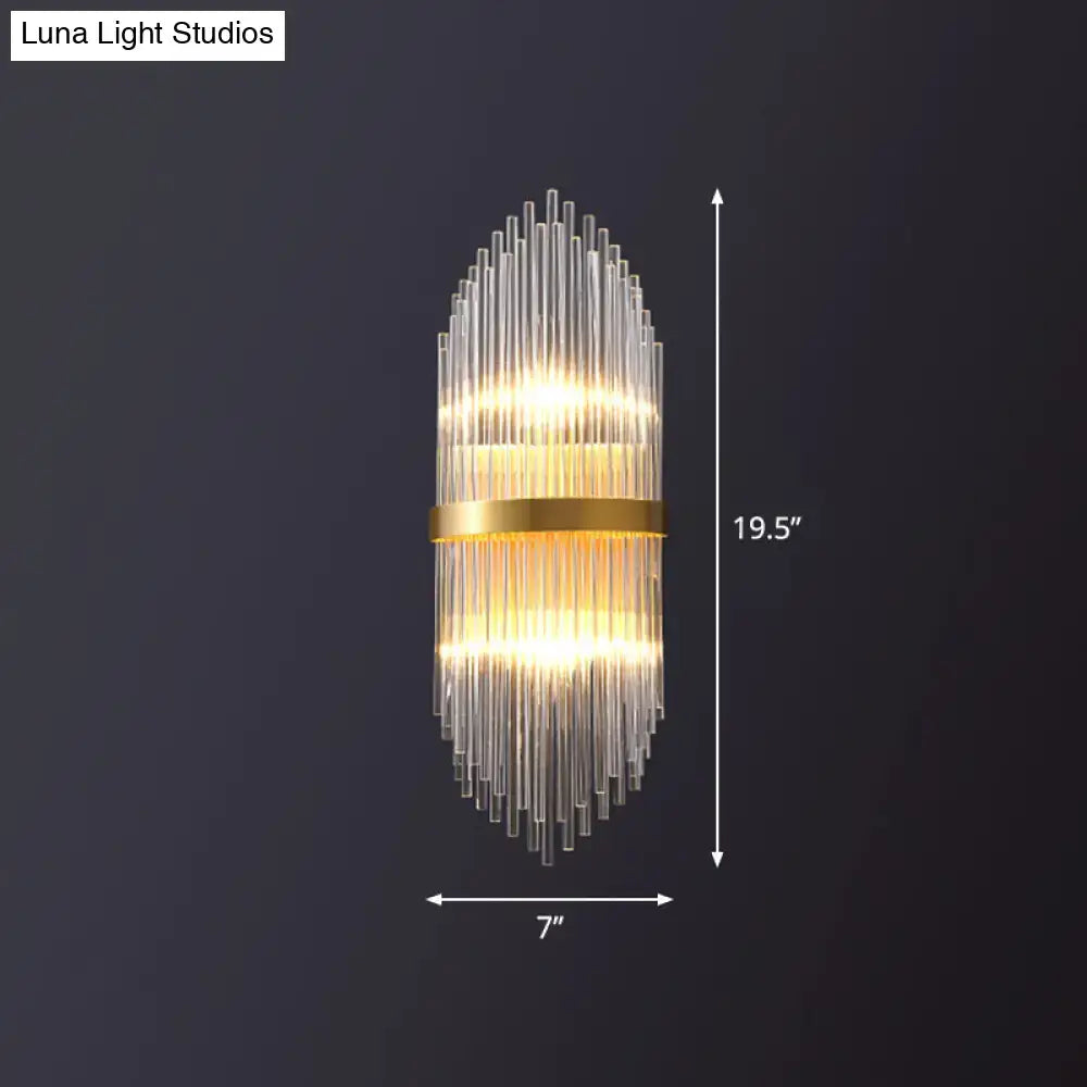 Modern gold flute shaped wall sconce with clear crystal rods and a metal frame for bedroom lighting