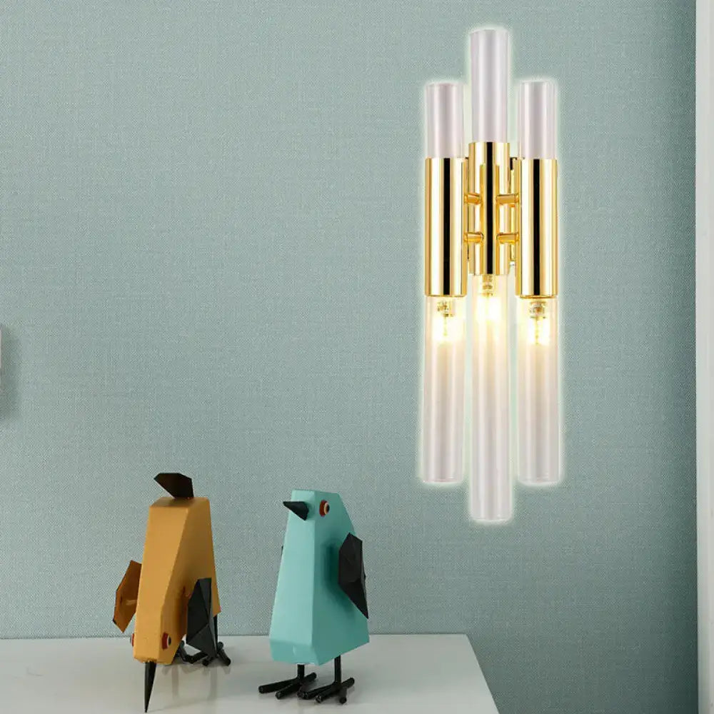 Modern gold frosted glass flute wall sconce with five vertical tubes and polished metal accents for living room lighting