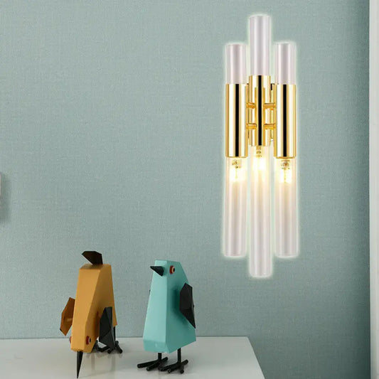 Modern gold frosted glass flute wall sconce with five vertical tubes and polished metal accents for living room lighting