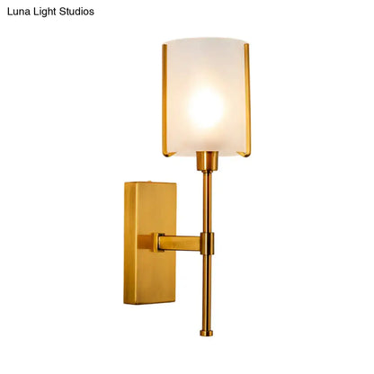 Modern brass-finished pencil arm wall sconce with frosted glass light fixture for bedroom lighting