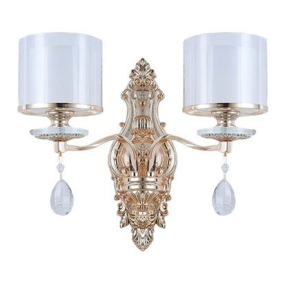 Modern gold wall lamp with frosted glass shades and crystal pendants creating an inviting glow for bedrooms