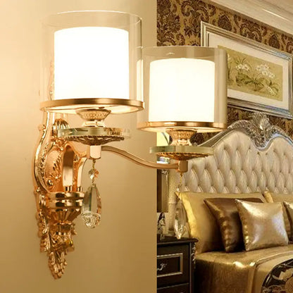 Modern gold ornate wall lamp with frosted glass shades and crystal droplets creating an inviting glow